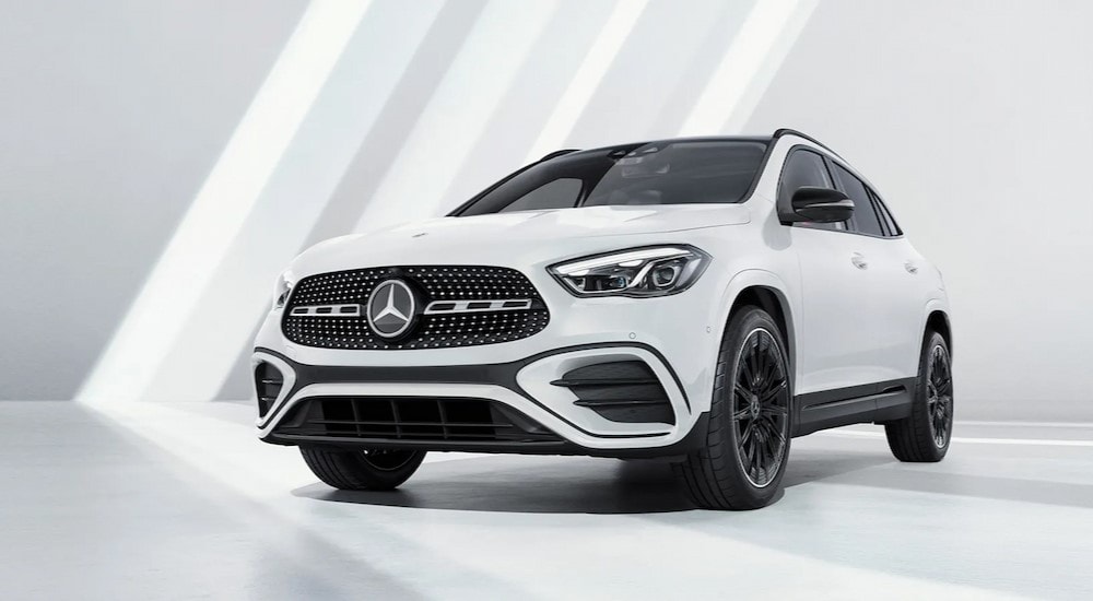 A white 2024 Mercedes-Benz GLA 250 is shown parked in a white room.