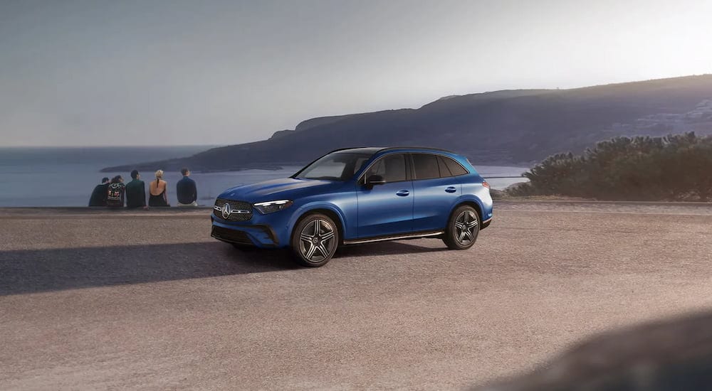 A blue 2025 Mercedes-Benz GLC 300 parked off-road and angled left.