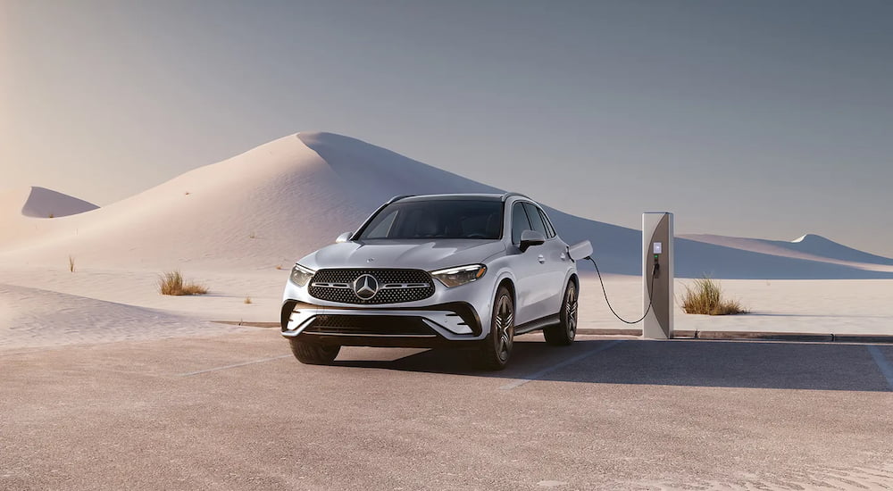 A white 2025 Mercedes-Benz GLC 300 parked by a charging station and angled left.