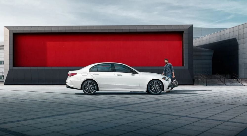 A white 2024 Mercedes-Benz C-Class is shown from the side after leaving a Mercedes-Benz dealer near West Chester.
