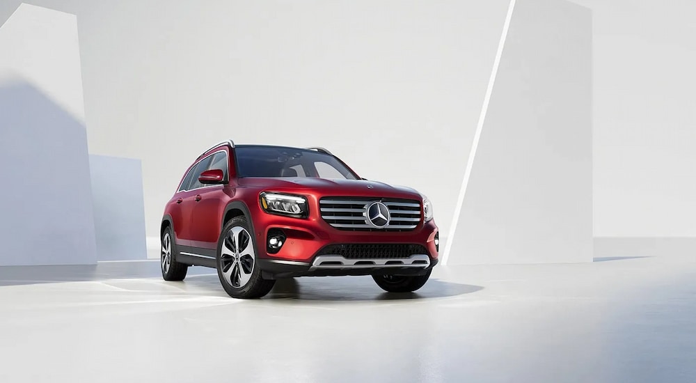 A red 2025 Mercedes-Benz GLB 250 Pinnacle parked in the showroom of a Mercedes-Benz dealer near Reading.