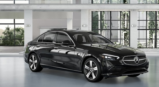 A black 2024 Mercedes-Benz C 300 parked in the showroom of a Mercedes-Benz dealer.