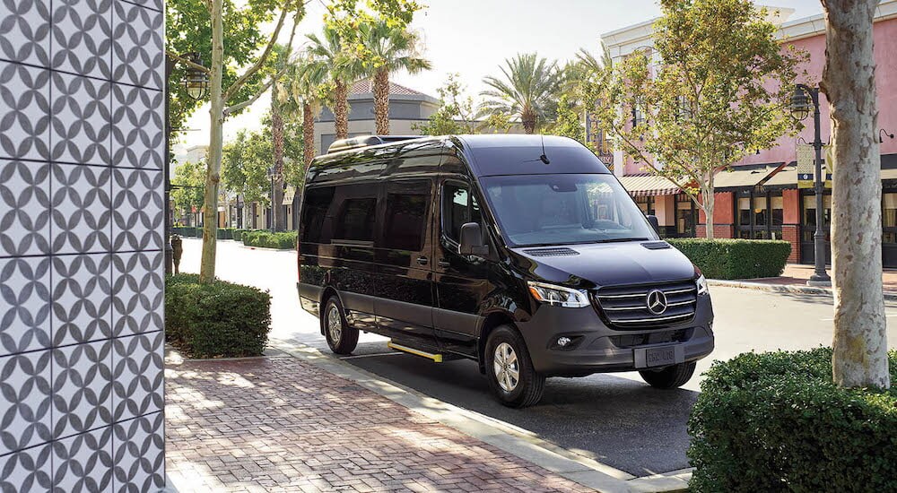 A black 2024 Mercedes-Benz Sprinter is shown from the front at an angle.