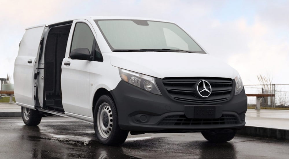 A white 2024 Mercedes-Benz Metris for sale is shown parked on a rainy day.