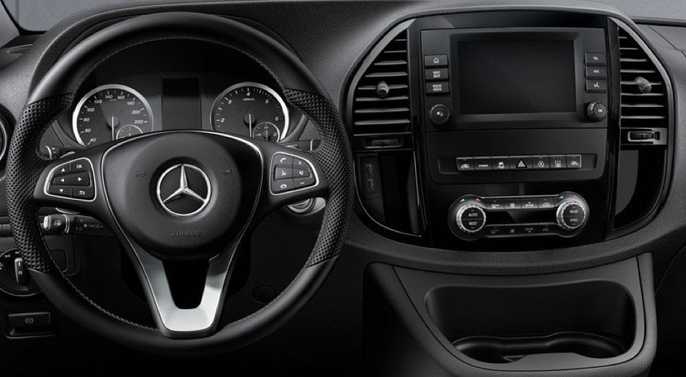 Close-up of the steering wheel and infotainment screen in a 2024 Mercedes-Benz Metris van.