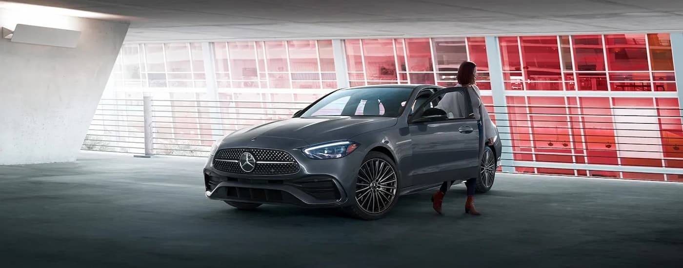 A grey 2024 Mercedes-Benz C-Class is parked in a parking garage after leaving a Mercedes-Benz dealer near West Chester.