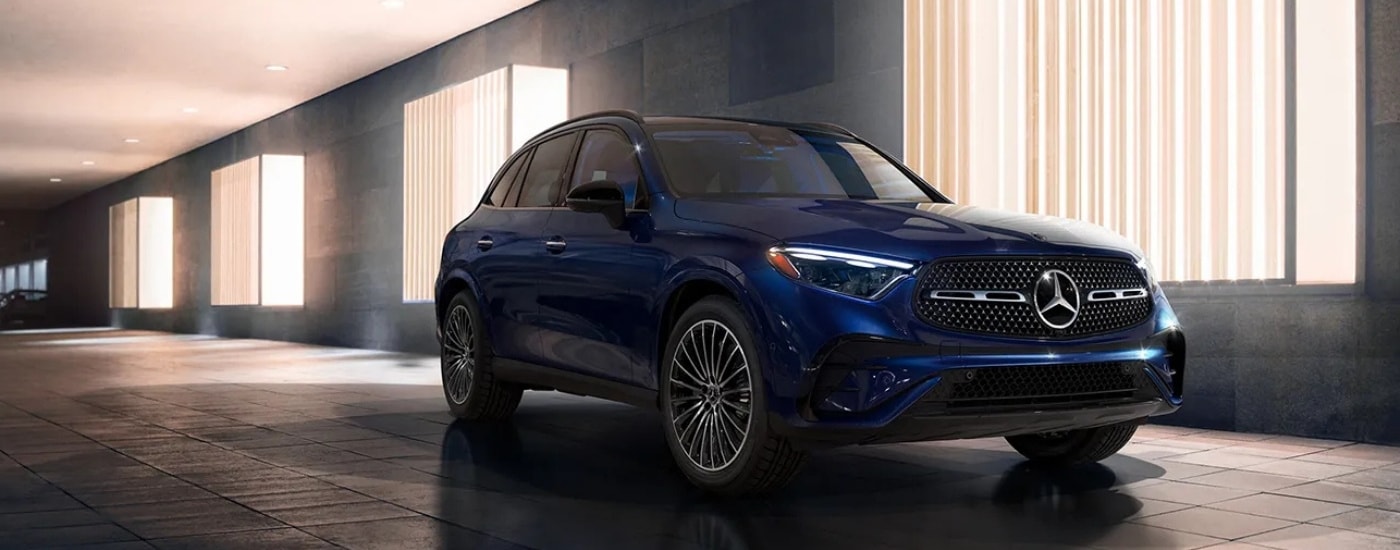 A blue 2024 Mercedes-Benz GLC for sale is shown from the front at an angle.