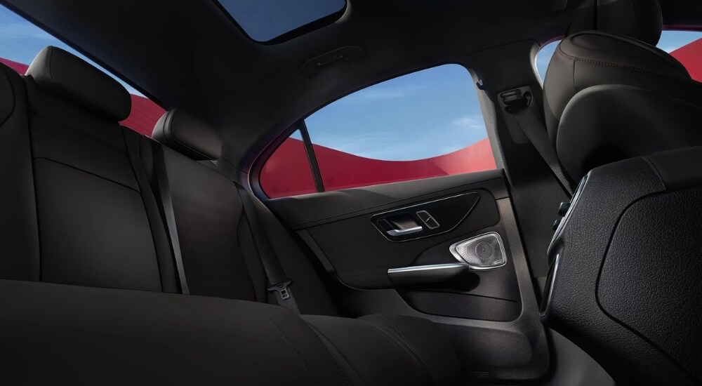 A close-up shows the rear black leather seats in a 2025 Mercedes-Benz C 300 Exclusive.