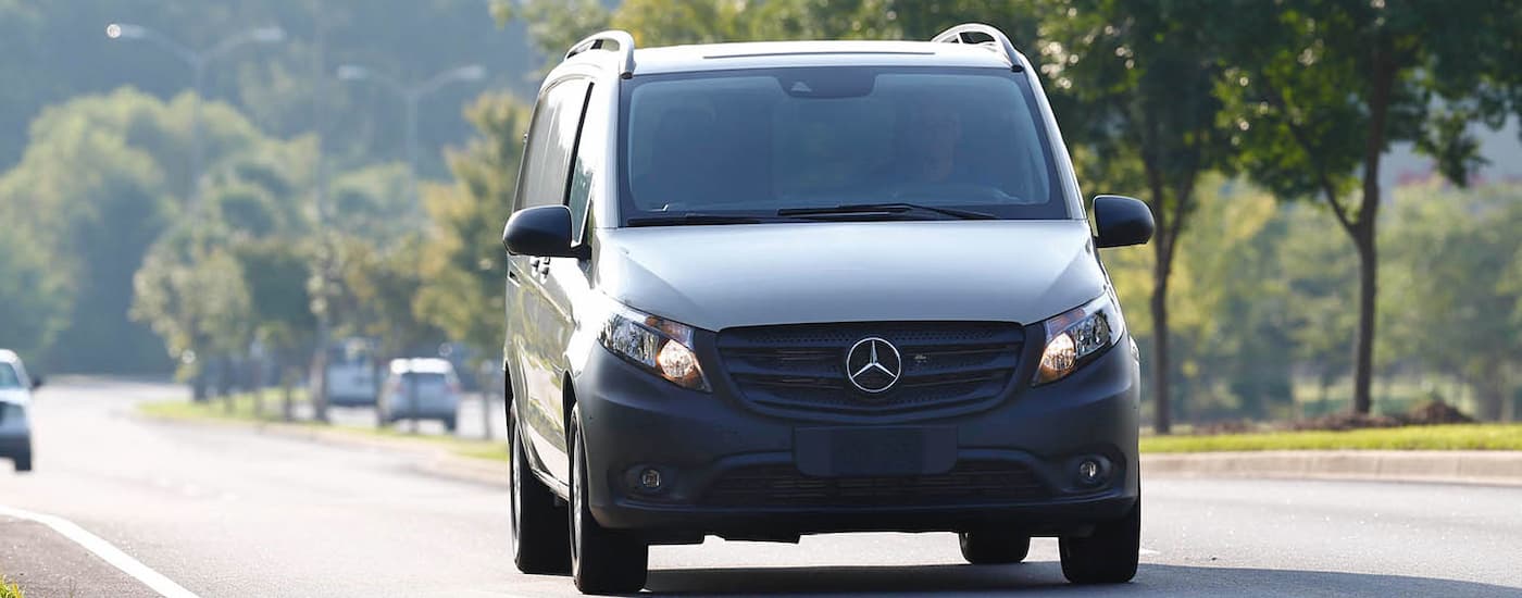 Front angle view of a white 2025 Mercedes-Benz Metris Cargo Van driving.