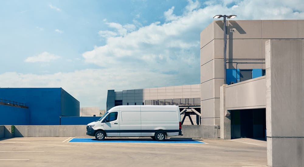 A white 2024 Mercedes-Benz eSprinter parked on a rooftop garage.