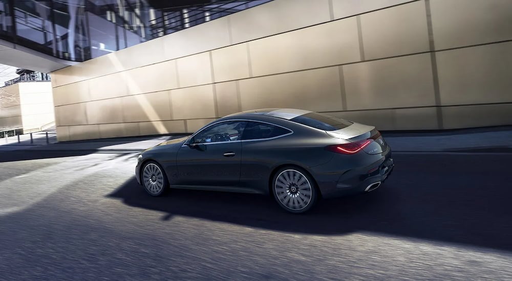 Rear angle view of a grey 2024 Mercedes-Benz CLE 300 4MATIC driving from a Mercedes-Benz dealer near Harrisburg.