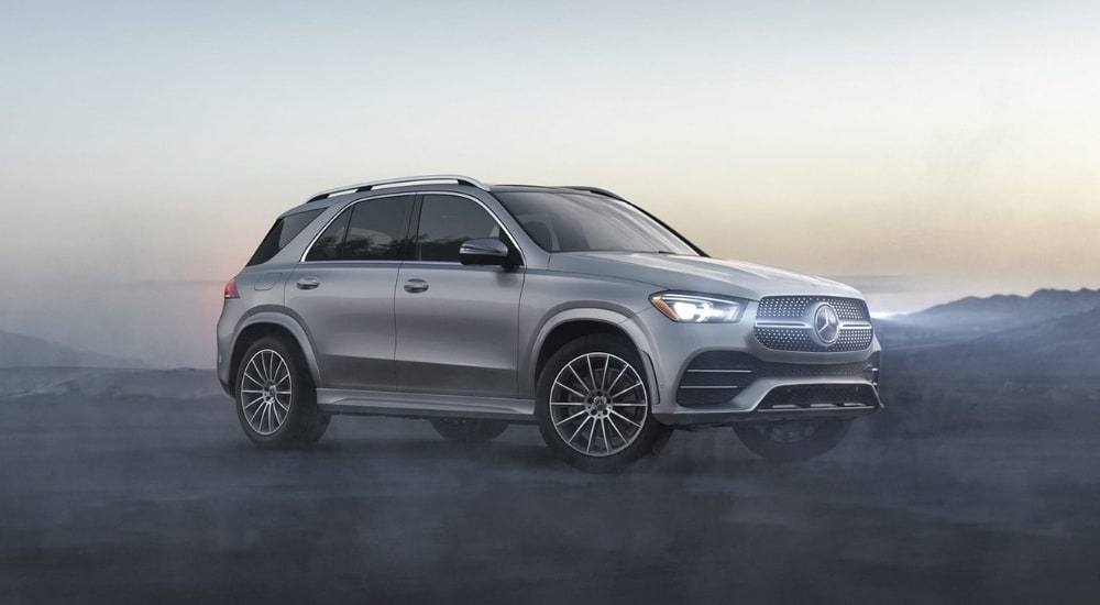 Side angled view of a grey 2020 Mercedes-Benz GLE parked off-road.