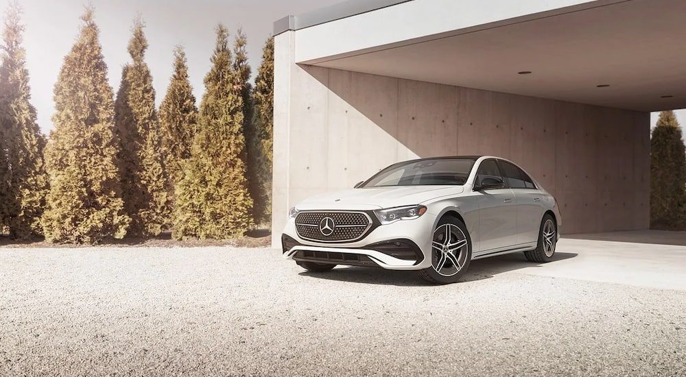 A white 2024 Mercedes-Benz E-350 4MATIC parked in a driveway after visiting a Mercedes-Benz dealer.