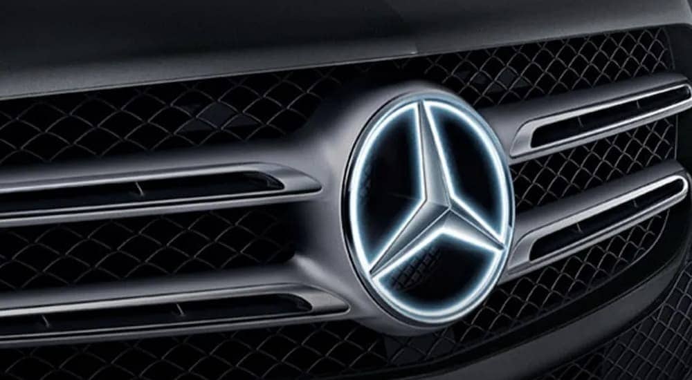 A close up of the illuminated badge on a 2025 Mercedes-Benz GLE 350.