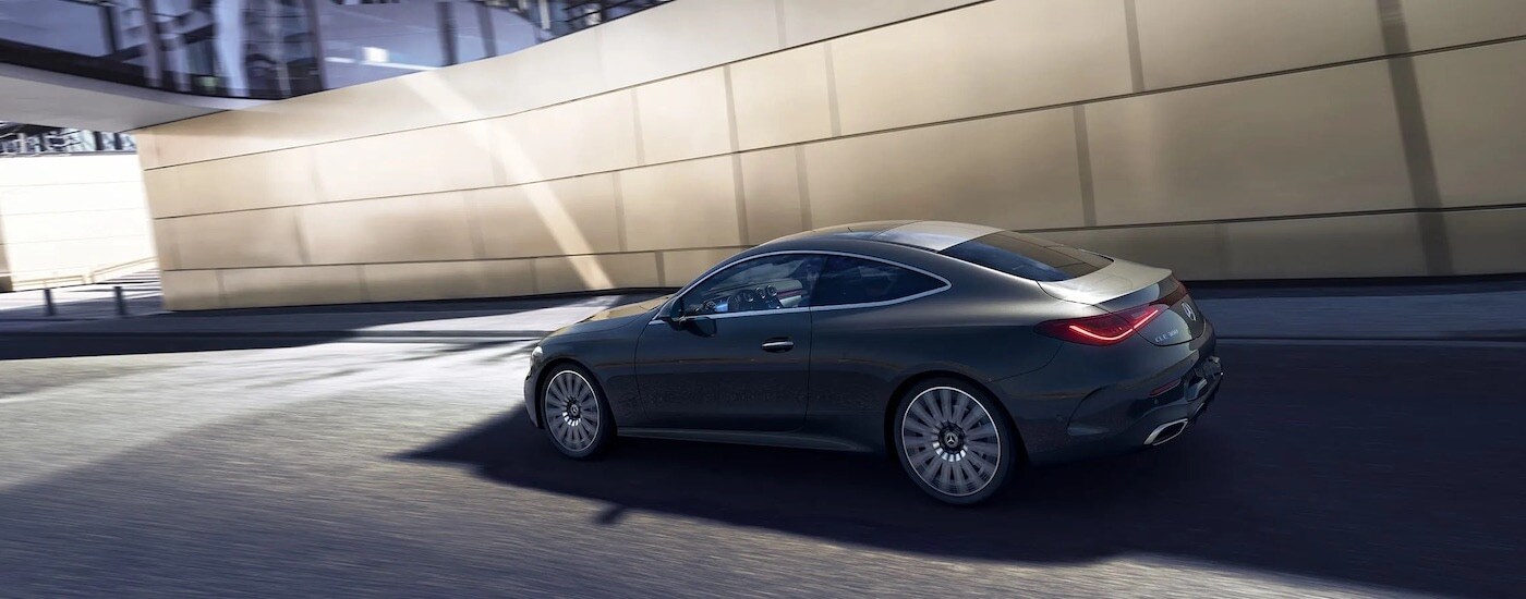 A grey 2024 Mercedes-Benz CLE Coupe is shown from the side after leaving a Mercedes-Benz dealer near Roseburg.