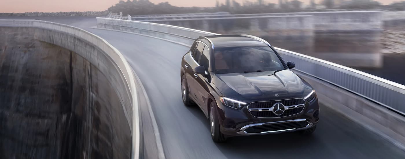 A black 2024 Mercedes-Benz GLC 300 driving across a bridge.