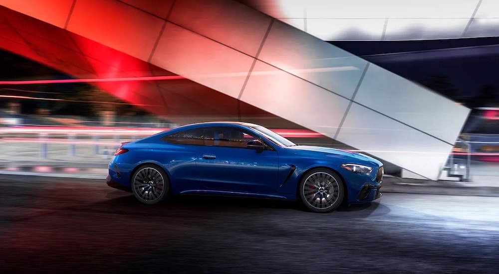 A blue 2022 Mercedes-AMG CLE 53 Coupe is shown from the side.