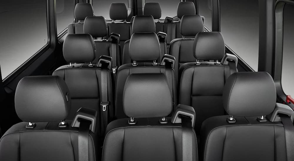 Rows of seating in a 2024 Mercedes-Benz Sprinter van for sale.
