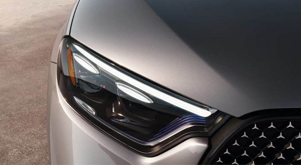 A close up shows the passenger side headlight on a silver 2023 Mercedes-Benz GLC.