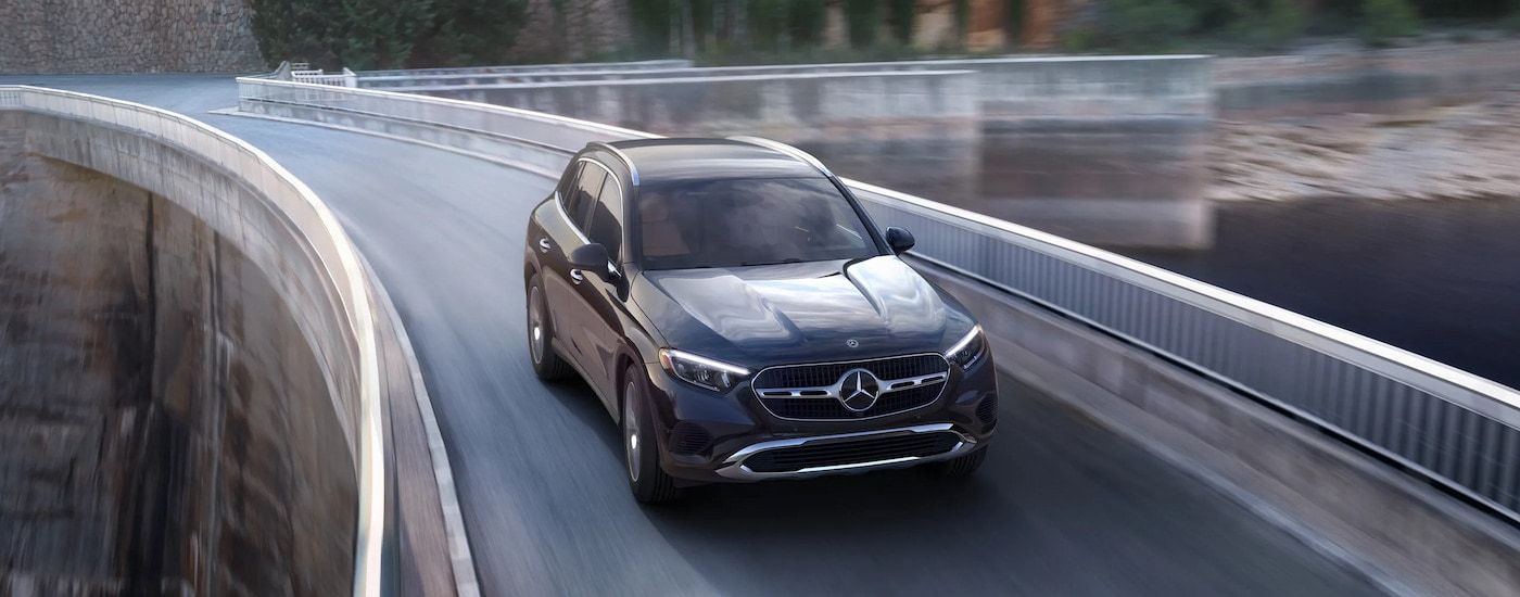 A black 2025 Mercedes-Benz GLC 300 driving over a bridge.