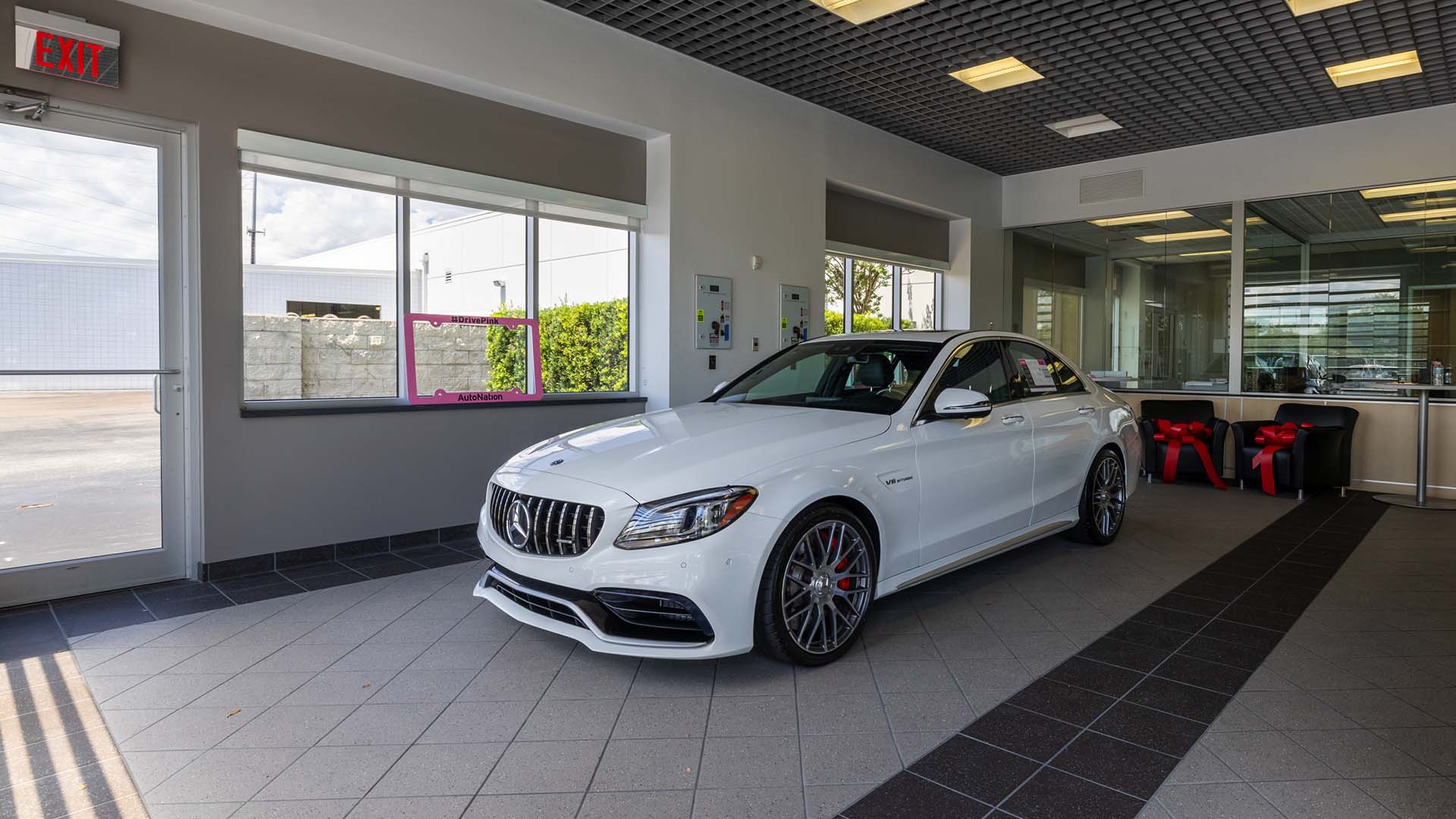 View of a white Mercedes-Benz sedan on the showroom floor at Mercedes-Benz of North Orlando