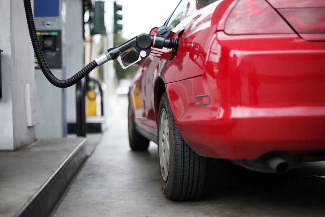 Red car fueling at a gas pump