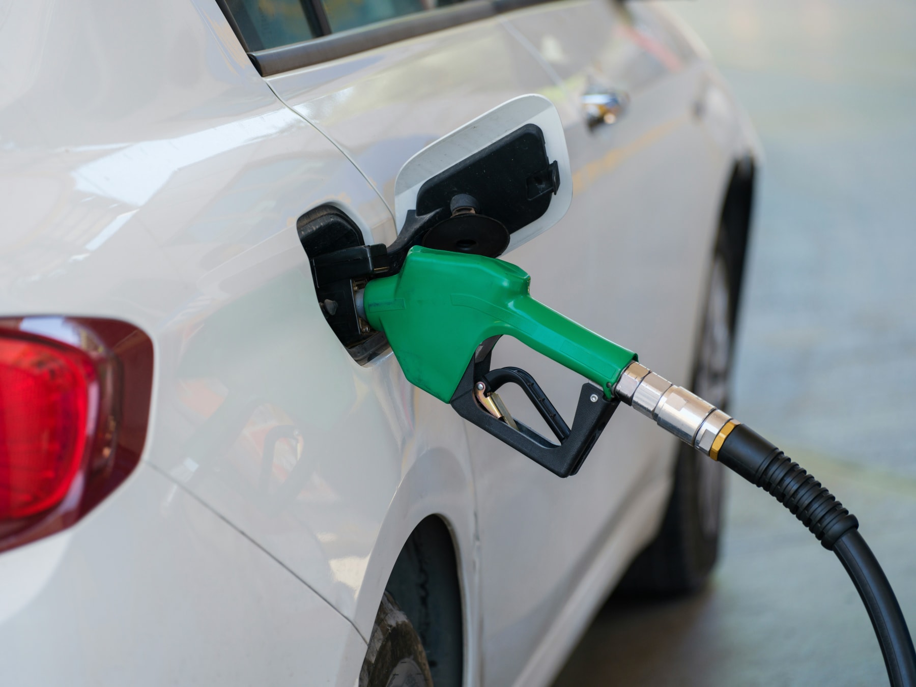 pumping gas into a white car