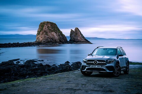Luxury SUV by Scenic Coastal Rock Formations