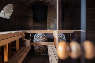 Serene sauna setup—cedar bench with sauna stones