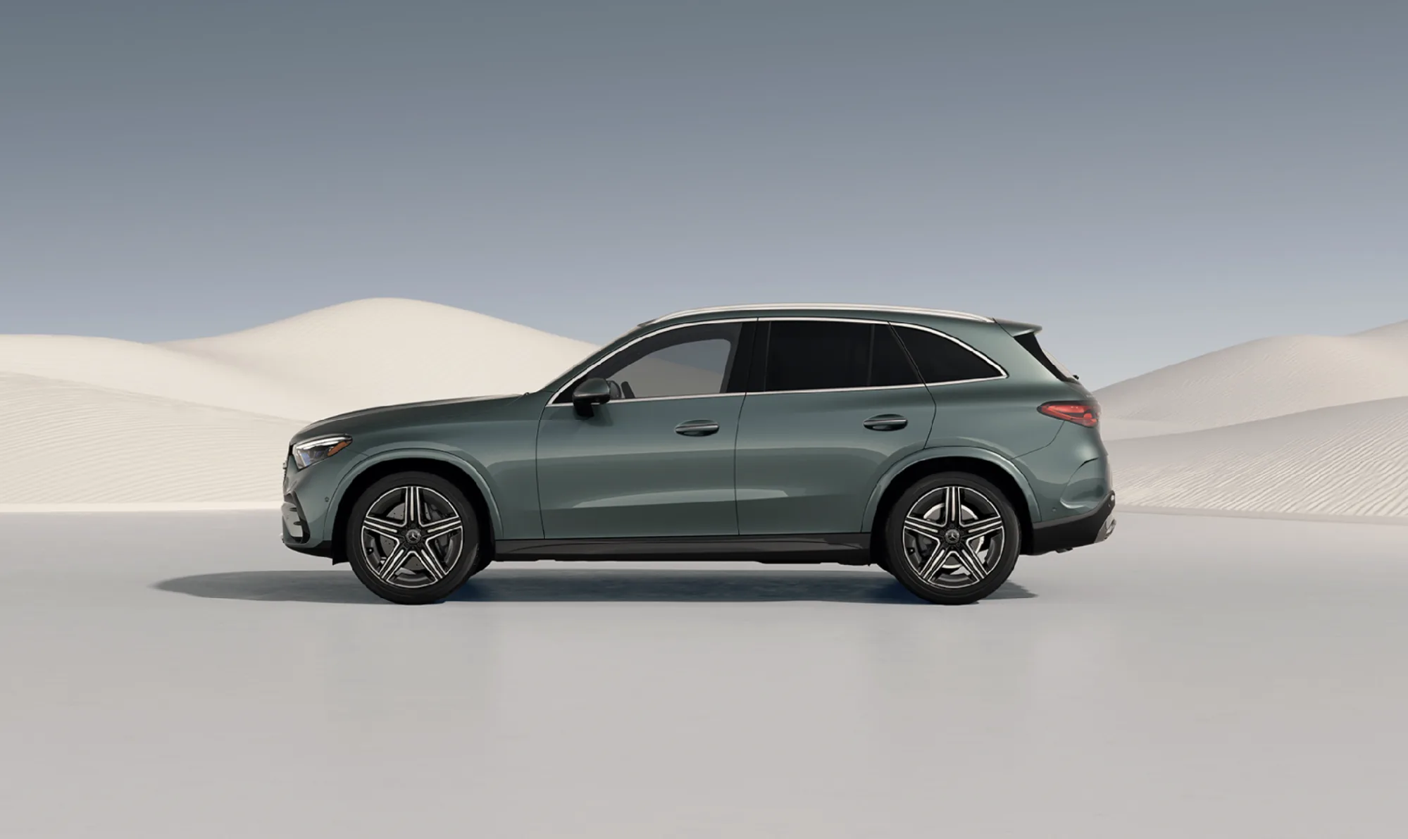 Side profile of Mercedes-Benz GLC 300 SUV parked against a desert dune backdrop
