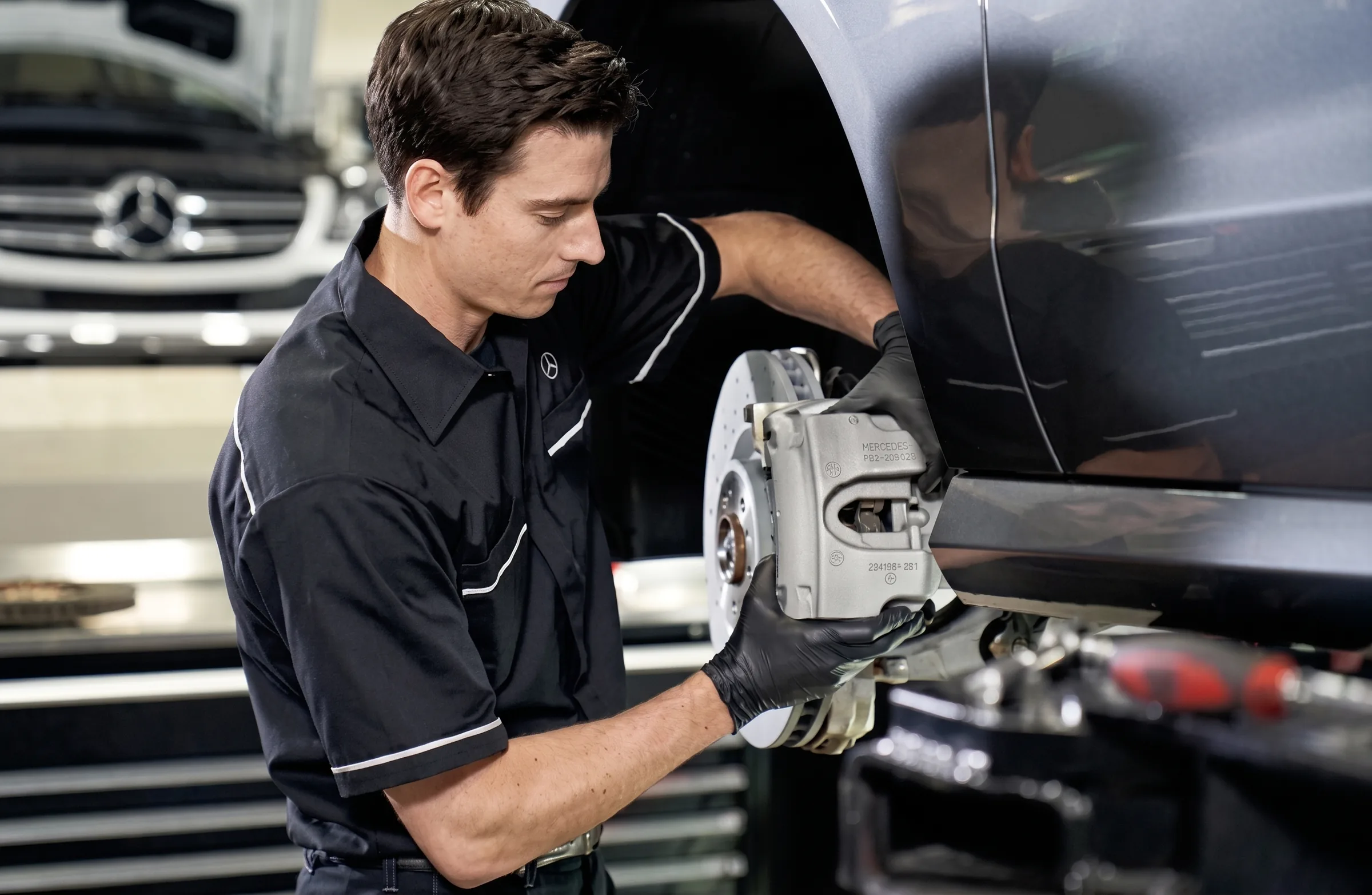 A service advisor going through paperwork on a clipboard with two customers beside a car