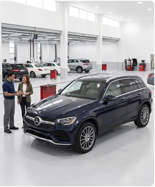 Service advisor handing a brake pad to a customer beside a dark blue Mercedes-Benz GLC in a bright dealership service department