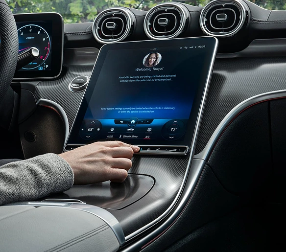Driver using the console fingerprint scanner below the C-Class MBUX touchscreen
