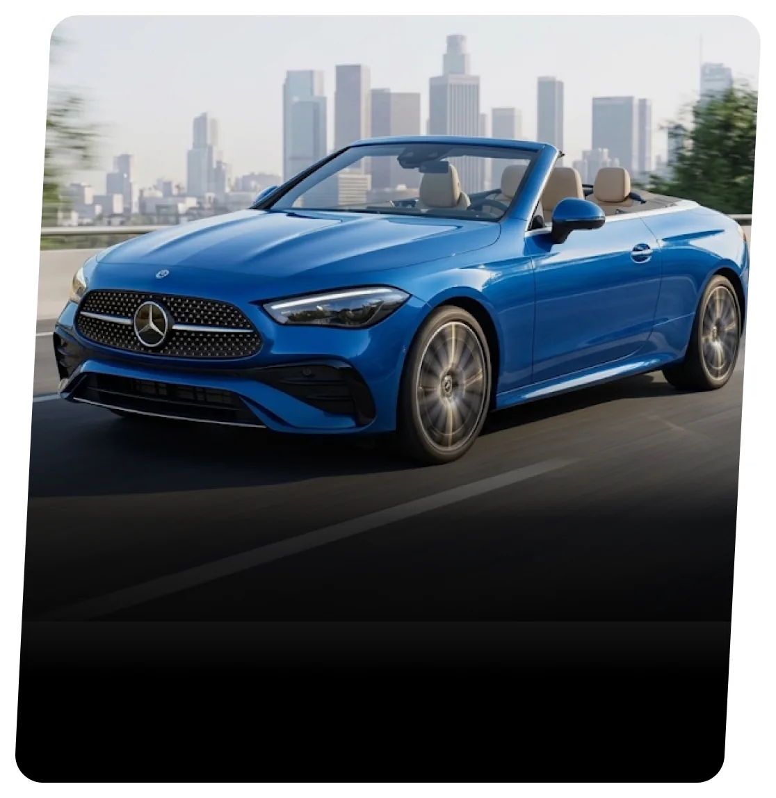 Blue Mercedes-Benz convertible with the roof down on a highway