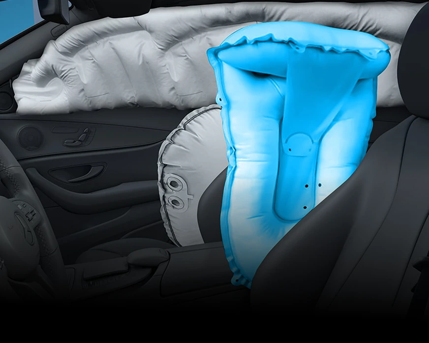 Cutaway of a C-Class front cabin showing the blue centre air bag deployed between the front seats
