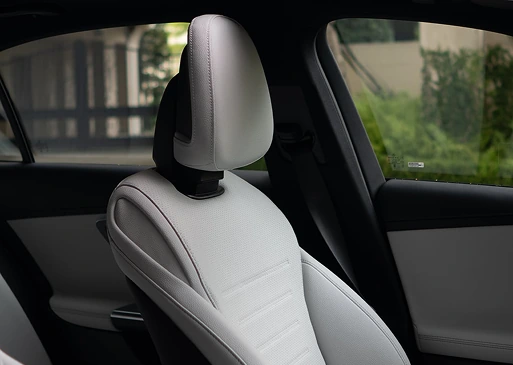 Light grey leather front seat and headrest inside a C-Class Sedan