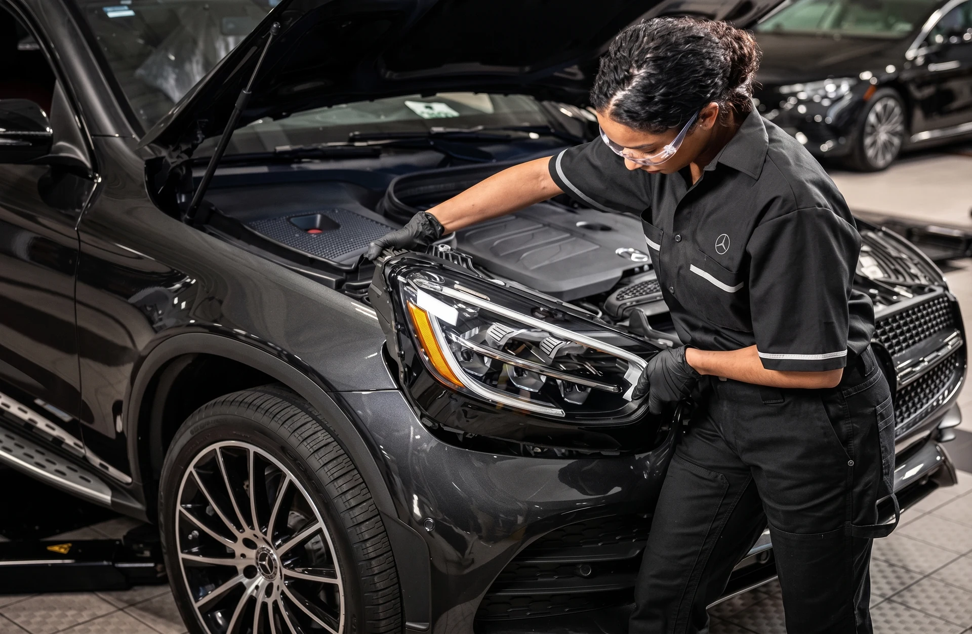A Mercedes-Benz technician checking under the hood