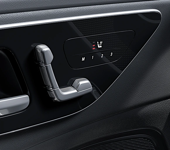 Seat-shaped power seat controls and memory buttons on a C-Class door panel