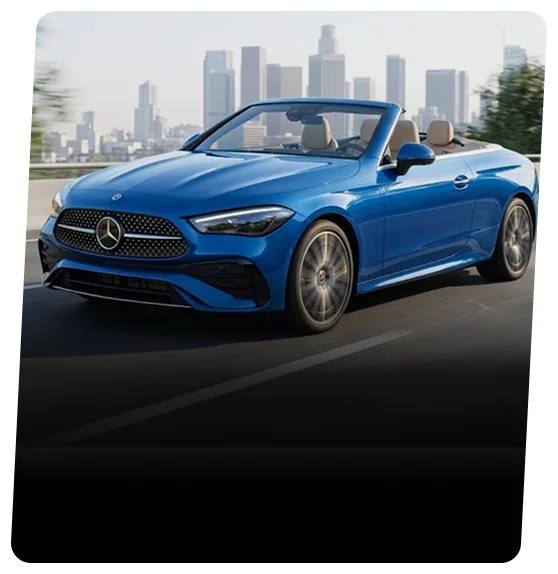 Blue Mercedes-Benz convertible with the roof down on a highway