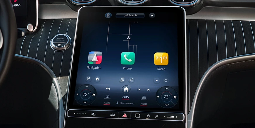 C-Class portrait MBUX touchscreen showing Navigation, Phone and Radio tiles above climate controls