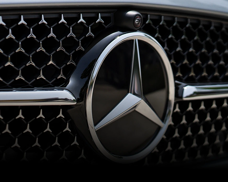 Close-up of the Mercedes-Benz star grille with a camera lens mounted above it