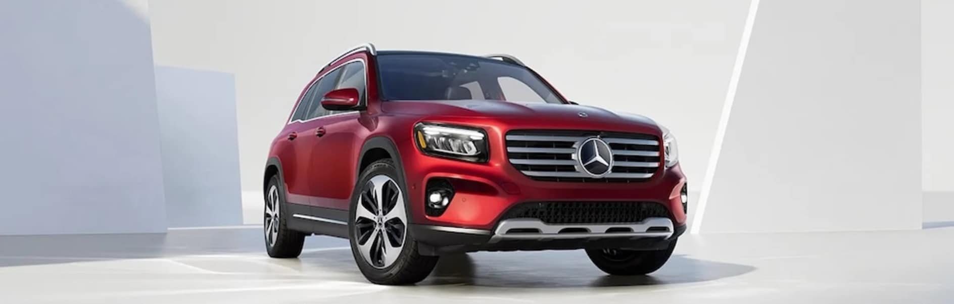 A red 2026 Mercedes-Benz GLB SUV in a white and grey space