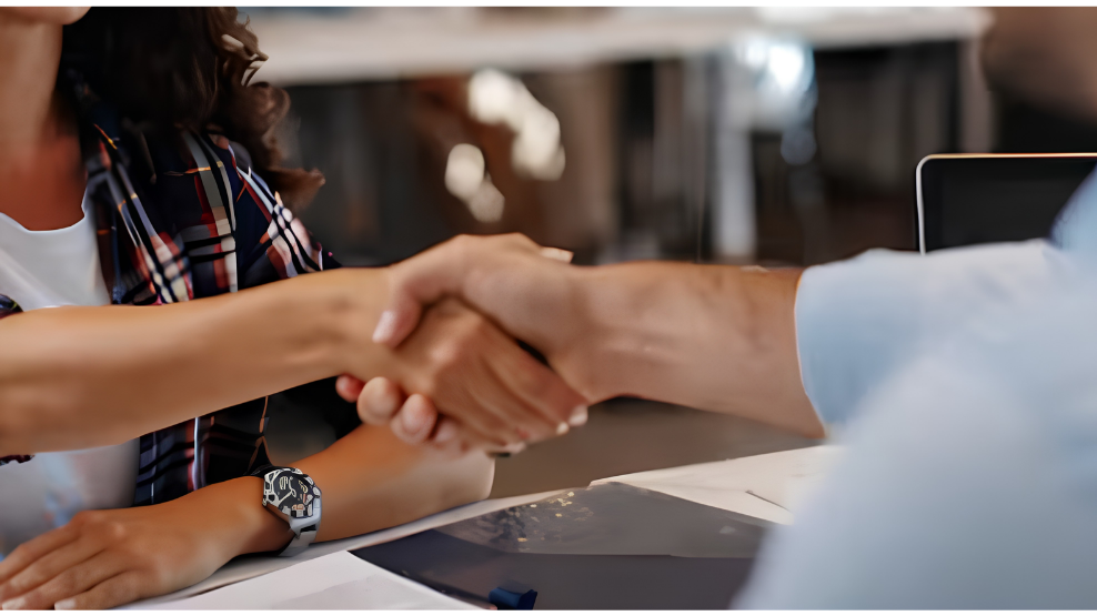 woman shaking hands with a salesman at a mercedes-benz dealership