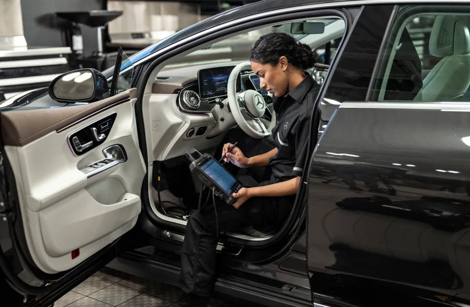 Certified Mercedes-Benz technician performing maintenance on a 2026 EQE Sedan