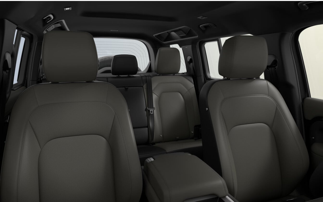 Interior view looking toward the rear seats of a 2026 Land Rover Defender 110 X-Dynamic SE cabin showing interior Khaki/Ebony Resist.