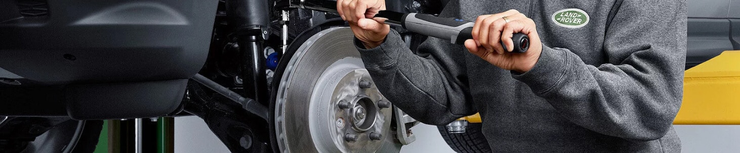 Land Rover suspension undergoes torque adjustment by a technician