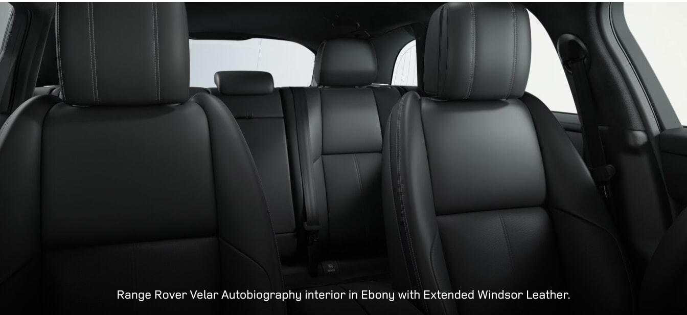 Interior cabin view of a Land Rover Range Rover Velar Autobiography showcasing premium Ebony leather seats.