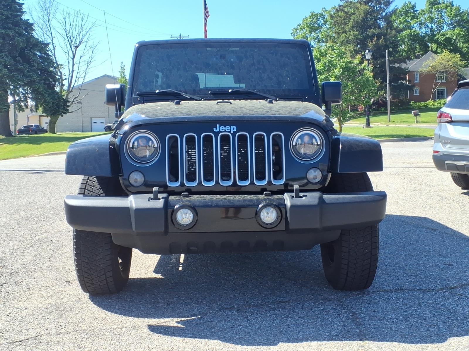 Used 2016 Jeep Wrangler Unlimited Sahara with VIN 1C4BJWEG0GL329210 for sale in New Era, MI