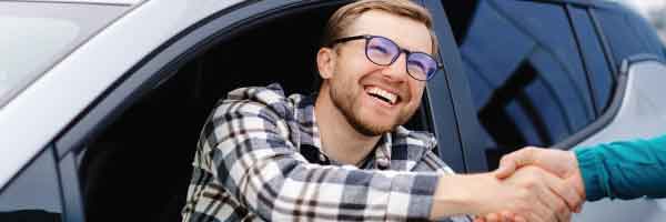  Happy customer shaking hands after a transparent pricing vehicle purchase at Upper Valley Auto Mart in White River Junction Vermont