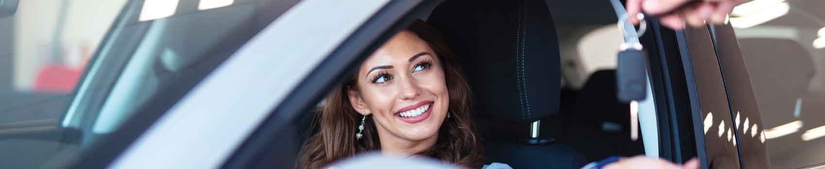 Customer picking up a used car after reviewing used car financing options at a dealership in White River Junction Vermont